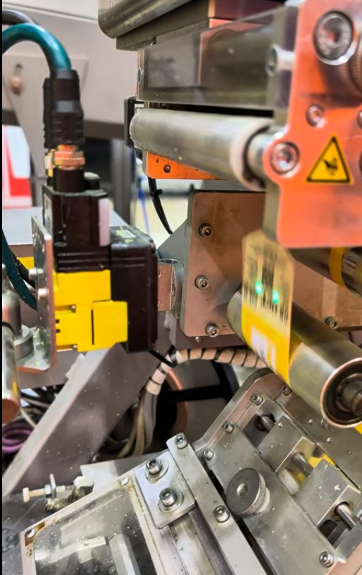 QR verification camera beside a printer on a packing line